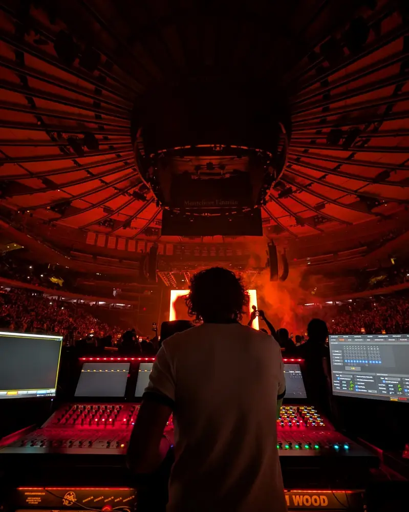 Tom at the console, arena lit red