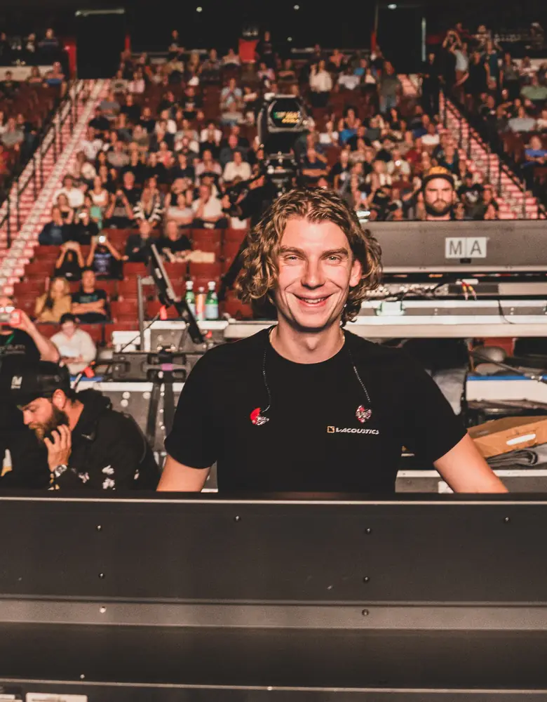 Tom smiling at front of house