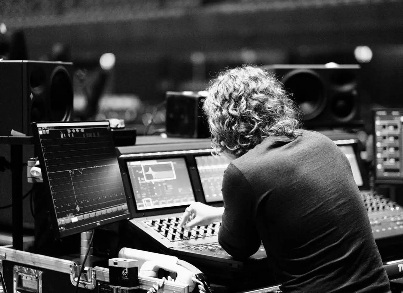 Tom at a console in black and white